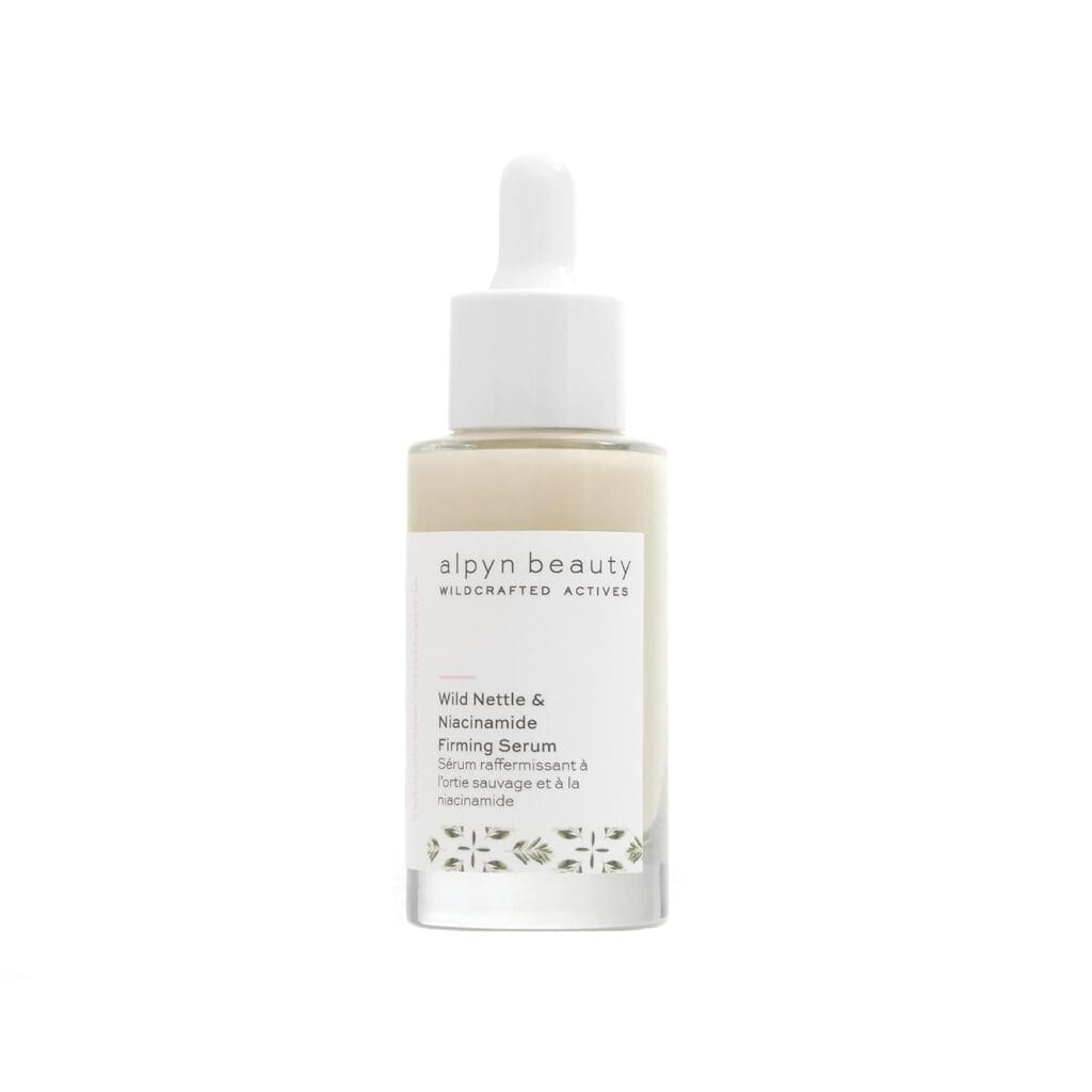 A single bottle of Alpyn Beauty Wild Nettle & Niacinamide Firming Serum isolated on a plain white background. The bottle features a clean, modern design with a white dropper cap and a label detailing the product name and key ingredients.