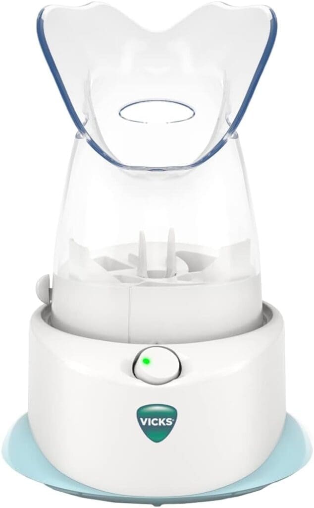 A close-up of the Vicks V1200 Personal Steam Inhaler, featuring a transparent face mask and an easy-to-use control knob, designed for respiratory comfort and sinus relief.